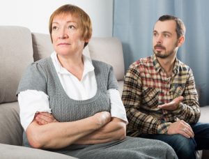 Older Mother on Couch Considers Disinheriting Son