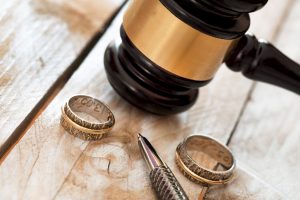 Close up of wedding rings and judge gavel